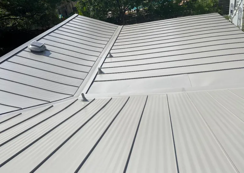 Solar attic fan installed on a metal roof for Roof Ventilation in Lumberton